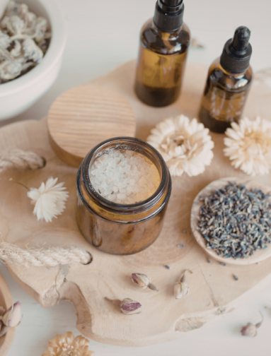 Natural apothecary ingredients including botanical oils, salts, and dried herbs.