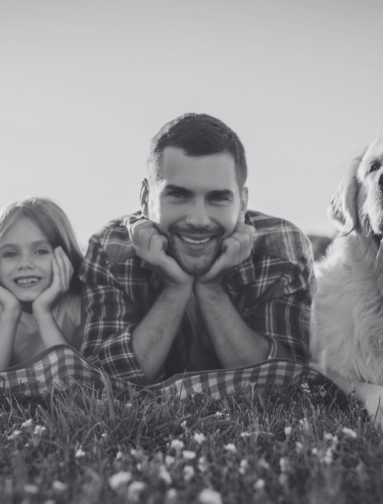 Man relaxing outdoors with dog, representing companion animal wellness and healthy lifestyle.